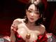 A woman in a red and black lingerie posing for a picture.